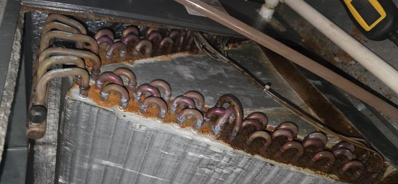 Responded to service call for air handler leaking issue. Upon inspection, found evaporator coil assembly showing significant corrosion and oxidation on copper tubing with visible moisture accumulation. Performed complete system maintenance including coil inspection, condensate drain line evaluation, and documented equipment condition with detailed photographs for customer records.
