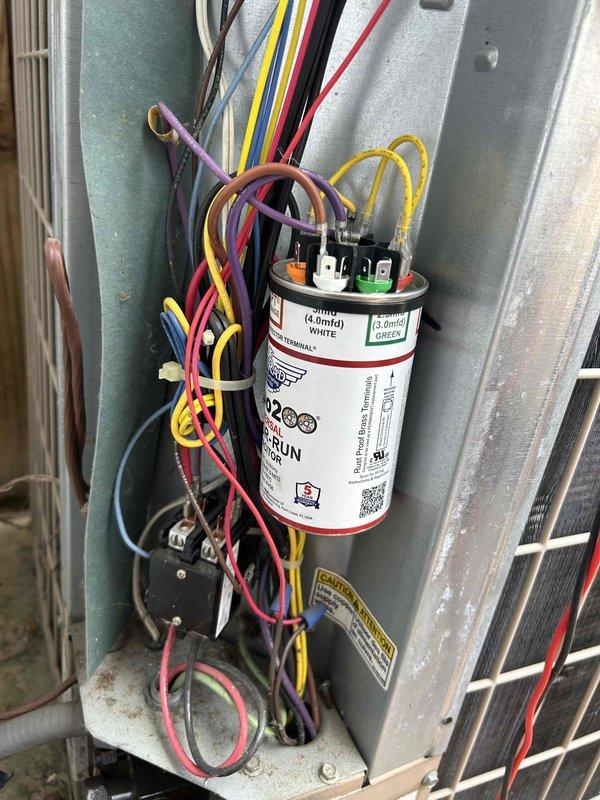 Responded to no cooling complaint on residential air conditioning system. Upon inspection, found failed dual-run capacitor preventing compressor and condenser fan operation. Replaced defective GE capacitor with new unit, verified proper microfarad ratings and voltage specifications, secured all electrical connections, and tested system operation. Unit restored to normal cooling operation with compressor and condenser fan running properly.