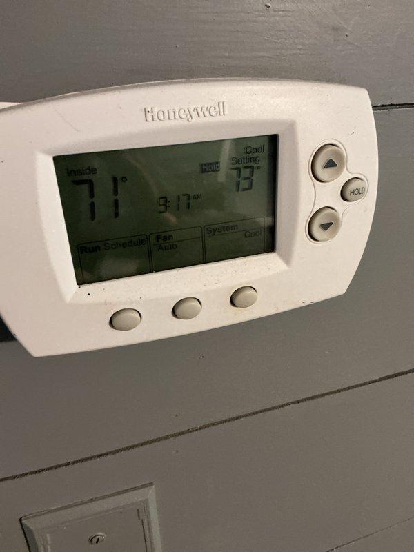 Completed cooling maintenance tune-up on residential HVAC system with reported inadequate cooling performance and extended temperature recovery times. Inspected Honeywell programmable thermostat operation, verified proper temperature differential settings, and examined indoor unit components including accumulator, copper refrigerant lines, and electrical connections. System showed evidence of normal condensation on accumulator, all electrical connections secure, and unit cycling properly to maintain setpoint temperatures.