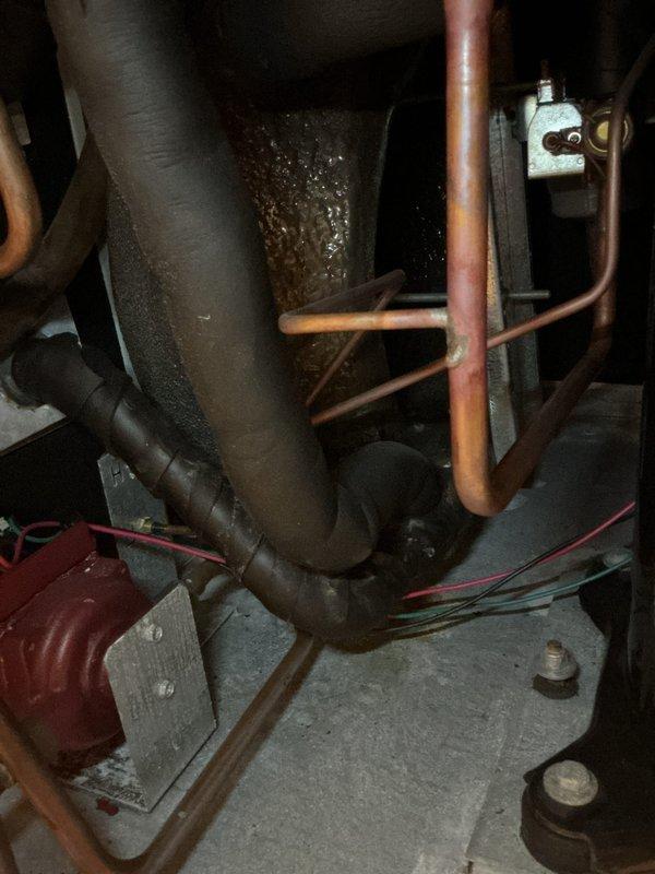 Completed cooling maintenance tune-up on residential HVAC system with reported inadequate cooling performance and extended temperature recovery times. Inspected Honeywell programmable thermostat operation, verified proper temperature differential settings, and examined indoor unit components including accumulator, copper refrigerant lines, and electrical connections. System showed evidence of normal condensation on accumulator, all electrical connections secure, and unit cycling properly to maintain setpoint temperatures.