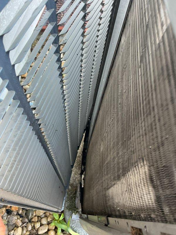 Completed annual cooling maintenance visit on CCHP system. Inspected outdoor condenser coils and found debris accumulation between heat exchanger fins; cleaned coils to restore proper airflow and heat transfer efficiency. Verified system operation with digital instrumentation at supply ductwork, confirming proper airflow and temperature readings throughout the system.
