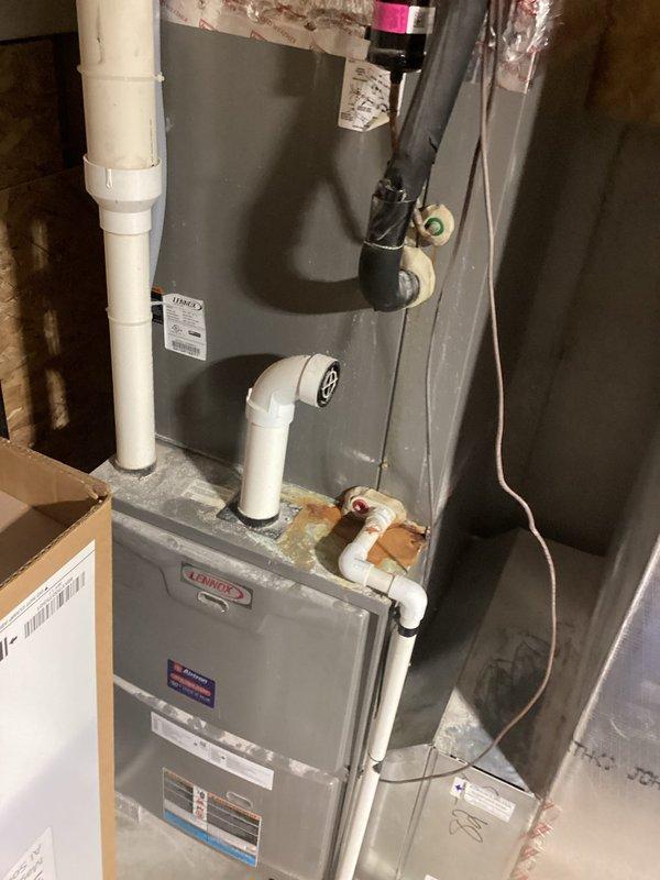 Responded to service call for Lennox air conditioning system not cooling properly and producing intermittent noise. Upon inspection of both the outdoor condensing unit and indoor furnace/air handler, performed diagnostic evaluation of the complete HVAC system. Assessed refrigerant levels, electrical connections, and mechanical components to identify the source of inadequate cooling and unusual operational sounds. Documented equipment condition with photographs showing proper installation configuration including condensing unit on exterior concrete pad with disconnect box and indoor air handler with PVC drainage and venting lines. Completed necessary adjustments and repairs to restore proper cooling function and eliminate noise concerns, returning system to normal operating parameters.