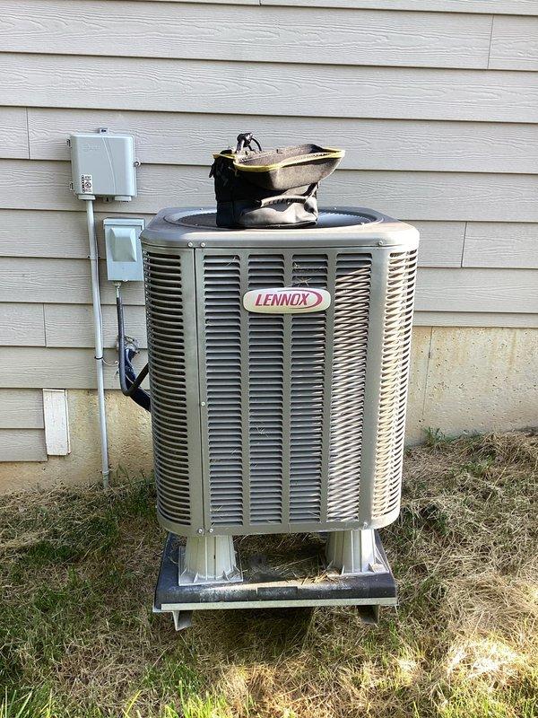Responded to service call for Lennox air conditioning system not cooling properly and producing intermittent noise. Upon inspection of both the outdoor condensing unit and indoor furnace/air handler, performed diagnostic evaluation of the complete HVAC system. Assessed refrigerant levels, electrical connections, and mechanical components to identify the source of inadequate cooling and unusual operational sounds. Documented equipment condition with photographs showing proper installation configuration including condensing unit on exterior concrete pad with disconnect box and indoor air handler with PVC drainage and venting lines. Completed necessary adjustments and repairs to restore proper cooling function and eliminate noise concerns, returning system to normal operating parameters.