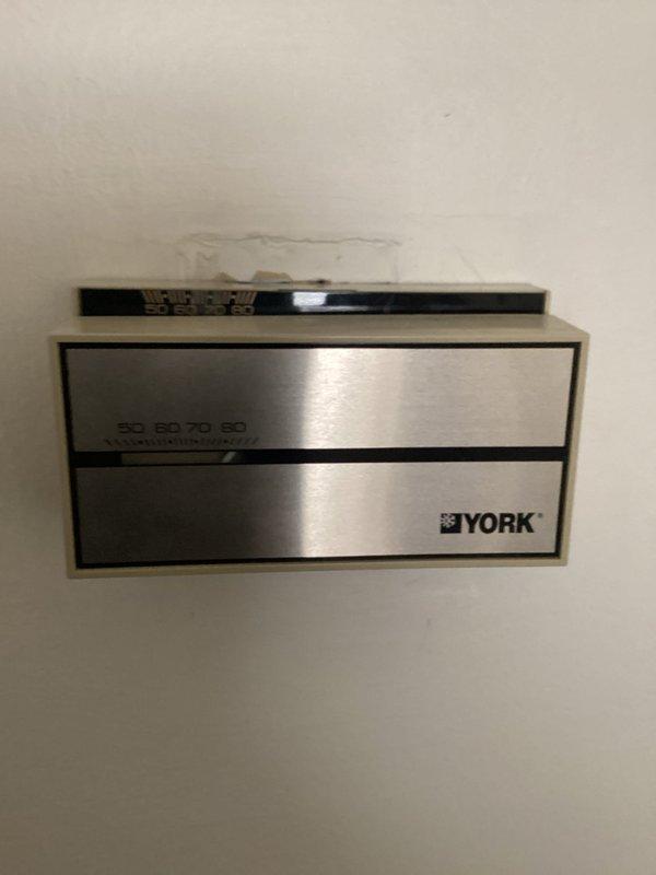Responded to no cooling complaint on York HVAC unit. Upon arrival, performed diagnostic assessment including temperature readings on refrigerant lines using digital thermometer, which indicated 81°F suction line temperature. Inspected indoor air handler and noted visible water damage on wall above unit, suggesting potential condensate drainage issues or previous leak. Documented equipment conditions with photos for service records. Further diagnostic testing required to determine if compressor failure is confirmed or if system issues stem from other components such as refrigerant loss, electrical failure, or control board malfunction.