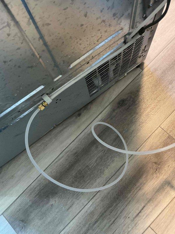 Responded to emergency water leak from refrigerator ice maker supply line. Upon arrival, identified compromised plastic water line with puncture causing active spray onto laminate flooring. Shut off water supply, removed damaged section of tubing, and installed new ice maker supply line with brass compression fittings to ensure leak-free connection. Verified system integrity and restored water supply with no leaks detected.