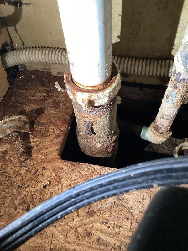 Responded to kitchen drain clog complaint and performed inspection of plumbing system beneath sink. Upon assessment, found garbage disposal unit and PVC drain assembly in working order with no visible blockages in the accessible trap configuration. Identified significant corrosion on copper plumbing components in the drainage system, including advanced oxidation with green patina buildup on copper fittings that may impact long-term system integrity. Cleared drainage issue and verified proper flow restoration through the disposal and drain lines.