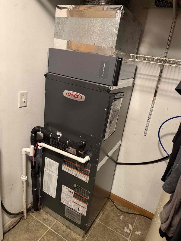 Completed full HVAC system installation including Lennox furnace unit and associated components. Installed 15KW electric heat accessory kit (model ECB48-15CB-P, 208/240V 60HZ 1PH) to provide supplemental heating capacity. Mounted furnace in utility area with proper clearances and connected all necessary ductwork, including plenum and filter housing with insulated transitions. Ran and secured white PVC condensate drain lines and venting pipes per manufacturer specifications. Verified all electrical connections, tested system operation, and confirmed proper airflow through supply and return ductwork. System commissioned and operating within normal parameters.