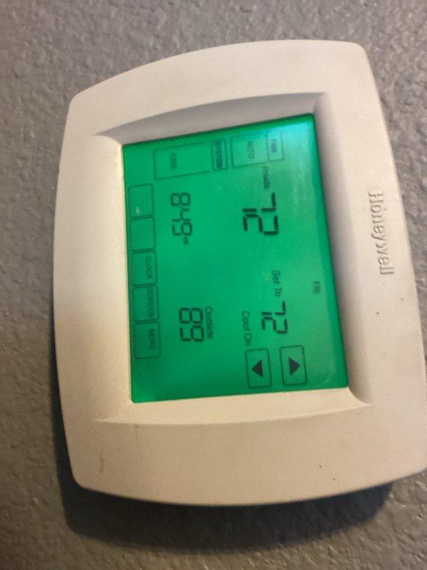 Responded to callback for system struggling to maintain setpoint temperatures throughout the day. Performed diagnostic evaluation of R410A system using refrigerant manifold and micron gauge at outdoor condenser unit. Measured operating pressures at 128.8 PSIG low side and 313.5 PSIG high side, with superheat reading of 44.3°F and subcooling at 10.1°F. Verified thermostat operation showing current temperature of 68°F with cooling setpoint at 72°F. System parameters indicate inadequate cooling capacity during peak load conditions requiring further evaluation of refrigerant charge and airflow.