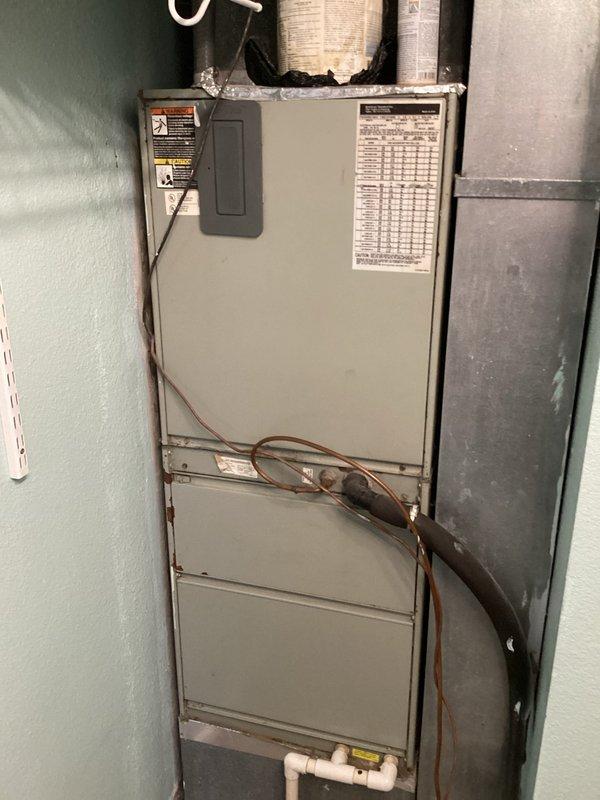 Responded to no-cooling call and performed diagnostic evaluation of residential HVAC system. Upon inspection, assessed furnace unit and air distribution components, including filter access area and ductwork connections. Documented system condition with photographic evidence showing existing equipment configuration, refrigerant line routing, condensate drain installation, and overall unit placement in mechanical closet. System evaluation completed to determine cause of complete unit failure reported by customer.