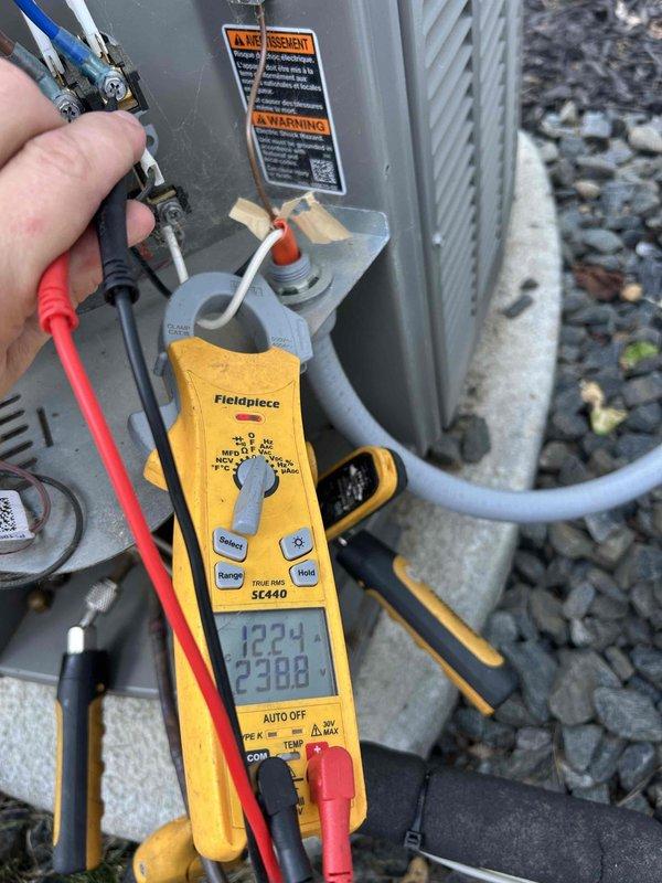 Completed annual basic cooling maintenance visit on residential air conditioning system. Performed visual inspection of blower wheel assembly, noting dust accumulation on squirrel cage fan blades and housing consistent with normal operation. Conducted electrical diagnostics on outdoor condensing unit using digital multimeter, recording voltage readings of 238.8V and 12.24V to verify proper power supply and control circuit operation. System operating within normal parameters; customer under active maintenance agreement with filter size 20x25x4 noted as not included in service plan.