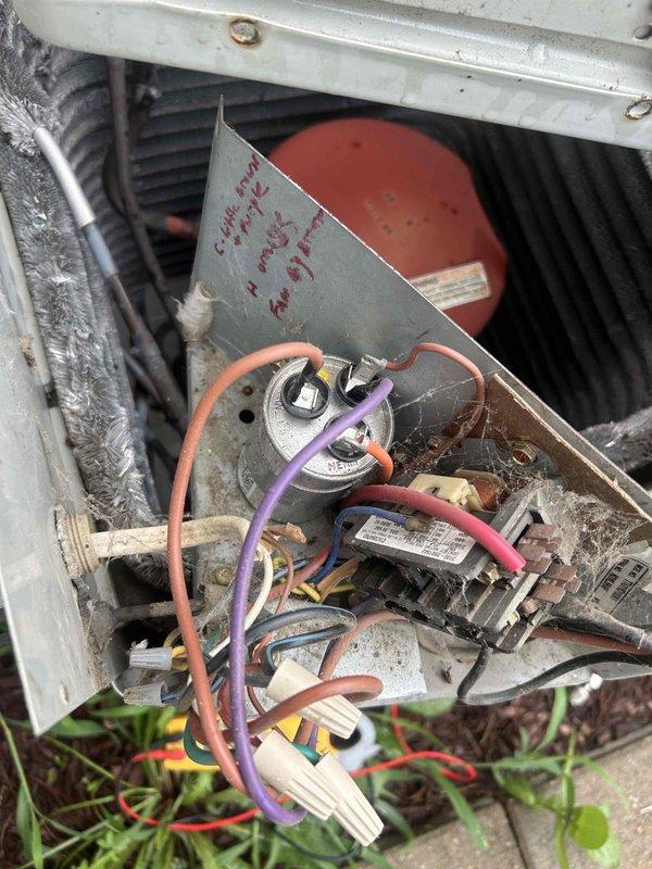 Responded to no cooling call on Trane XE 1100 split system where outdoor condenser unit was not running while indoor air handler fan operated normally. Inspected outdoor unit electrical components including capacitor and wiring connections, documented system condition with photographs showing aged components with accumulated dirt and general wear. Diagnosed failure, performed necessary repairs to restore outdoor unit operation and system cooling capacity.