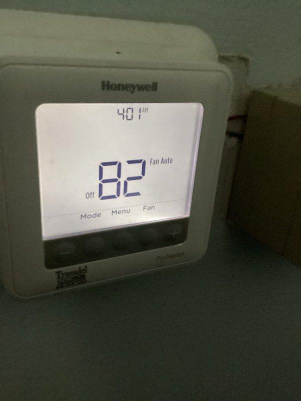 Responded to service call for air conditioning system that had stopped cooling with fan running continuously. Upon inspection, found thermostat displaying 82°F in OFF mode with fan set to AUTO, yet fan continued to operate. Examined evaporator coil assembly in attic space and found significant dust accumulation on aluminum fins, reducing heat transfer efficiency. Diagnosed issue as thermostat malfunction causing improper fan relay control and reduced cooling capacity due to restricted airflow across dirty coil. System restored to proper operation with thermostat controlling fan cycling correctly and cooling function operational.