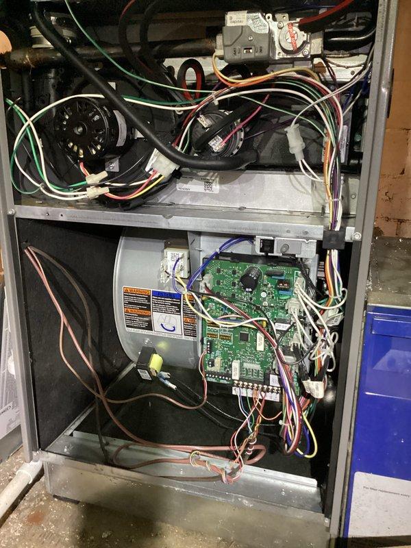Replaced defective ECM blower motor under warranty. Removed failed motor from furnace cabinet, installed new ECM motor, verified proper electrical connections and control board communication, and tested system operation to confirm successful repair.