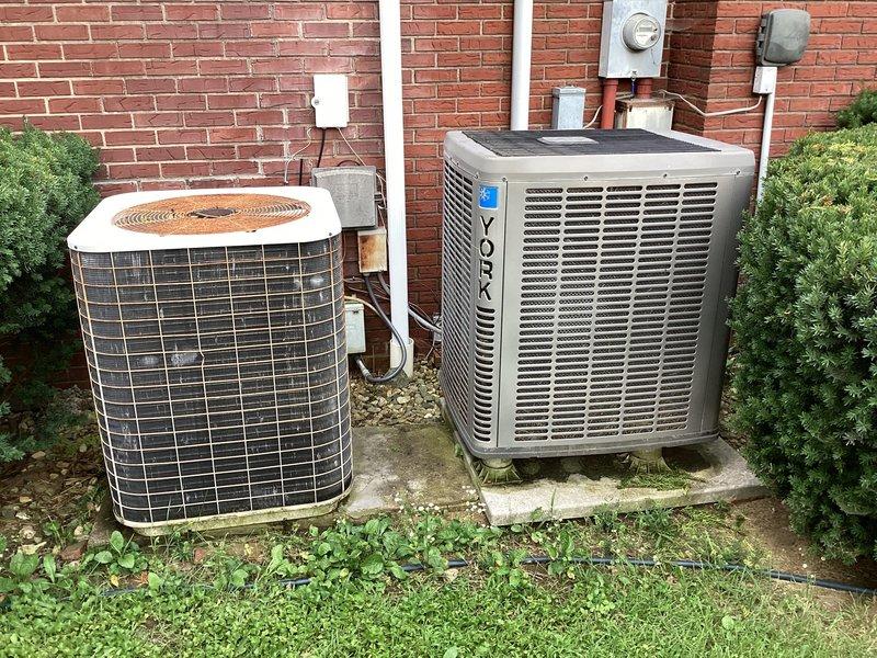 Responded to cooling complaint where system was running continuously but unable to maintain temperature below 80 degrees. Upon arrival, inspected two outdoor condensing units serving the residence - one older cylindrical unit and one newer York rectangular unit. Performed system diagnostics and electrical panel inspection, documenting equipment condition and breaker configuration including 50-amp circuits serving the HVAC equipment. Identified cooling deficiency and provided recommendations for restoring proper system operation and temperature control.