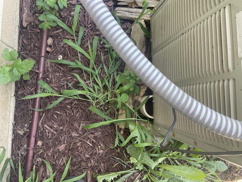 Conducted comprehensive cooling system evaluation on 28-year-old Trane XE 1100 air conditioning unit located on exterior concrete pad. Documented existing equipment condition, installation configuration, and surrounding infrastructure including gas meter proximity and electrical disconnect placement. Provided replacement estimate and recommendations based on system age and current operating status.