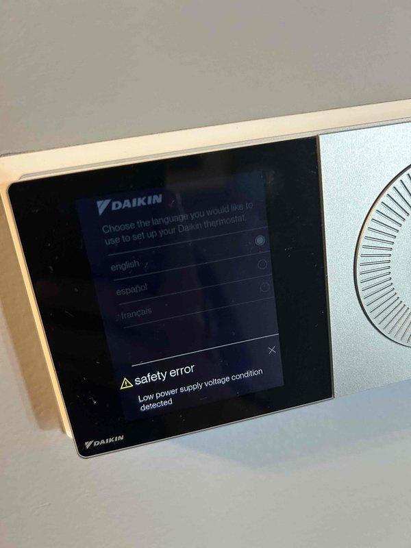 Responded to no cooling complaint on Daikin heat pump system. Upon arrival, found thermostat displaying safety error with low power supply voltage condition detected. Reviewed error history showing multiple fault codes including heat pump low voltage conditions and electrical faults dating back several months, indicating ongoing power supply issues affecting system operation and preventing normal cooling mode.
