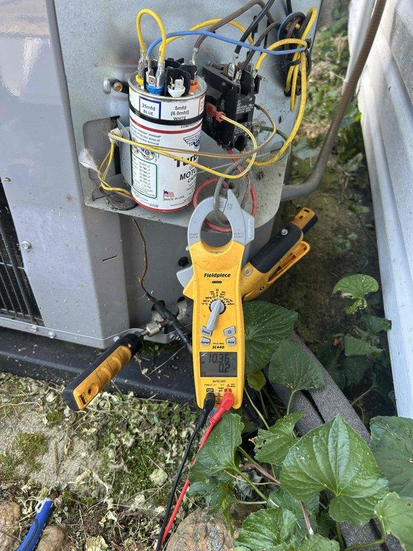 Responded to no cooling complaint on 10+ year old residential air conditioning system. Performed electrical diagnostics on outdoor condenser unit using digital multimeter and clamp meter. Tested capacitor functionality and measured voltage/amperage at compressor and fan motor connections. Evaluated overall system performance and provided recommendations for aging equipment. Unit operational upon departure.