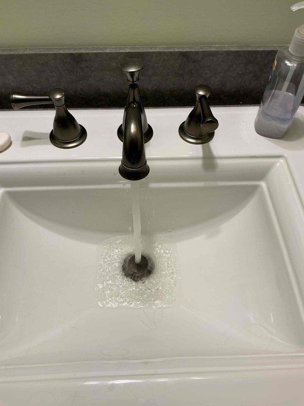 Completed monthly plumbing inspection for prepaid maintenance membership. Performed comprehensive evaluation of bathroom fixtures including sink faucet operation, shower valve functionality, and water flow testing. Documented current condition of plumbing fixtures with photographic evidence showing proper water pressure and drainage performance, while noting tile grout and fixture surfaces that may require future attention for optimal maintenance.
