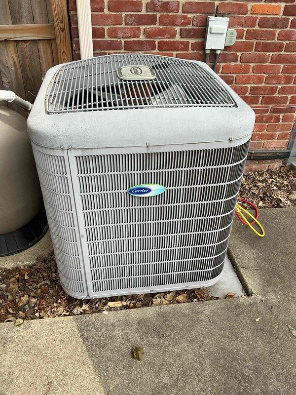 # HVAC Maintenance - Cooling System Service

Completed comprehensive monthly cooling maintenance on Carrier outdoor condensing unit. Performed standard inspection of electrical components including Turbo 200 capacitor (5mfd, 370V) and contactor assembly, verifying all wire connections and terminals were secure with proper color-coded wiring intact. Inspected refrigerant line connections at brass fittings and confirmed system integrity. Evaluated condenser cabinet condition, fan grille assembly, and airflow pathways through horizontal fin panels. Cleared debris and leaves from unit base and surrounding concrete pad to ensure unrestricted airflow and proper drainage. Verified disconnect box accessibility and overall unit operation. All electrical components functioning within normal parameters with no immediate service needs identified during this routine maintenance visit.