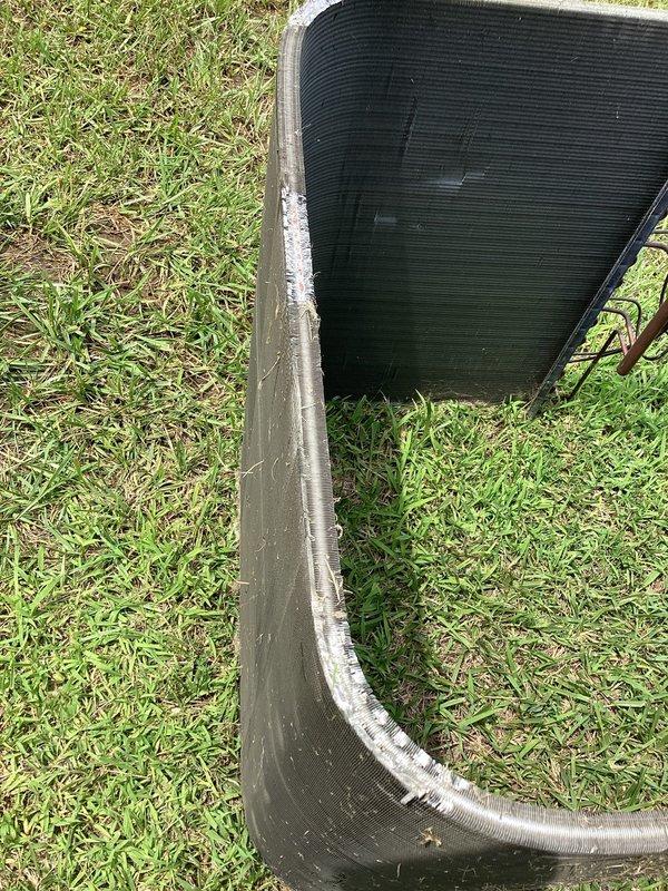 Performed condenser coil repair on outdoor air conditioning unit. Inspected refrigerant line set connections at condenser base and verified proper insulation on refrigerant lines. Unit operational upon completion with all connections secure and system functioning as designed.