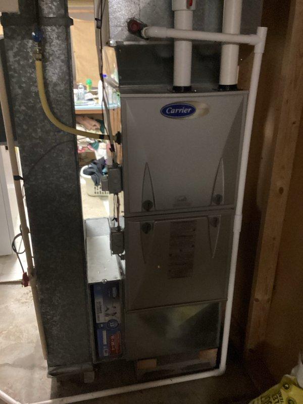 Responded to no cooling call with ice formation on system. Found frozen evaporator coil on Carrier unit. Verified blower operation normal. Diagnosed restricted airflow as cause of freezing condition. Allowed system to thaw completely, replaced dirty air filter, and confirmed proper airflow restoration. Checked thermostat programming and temperature settings. System tested and operating within normal parameters upon departure.