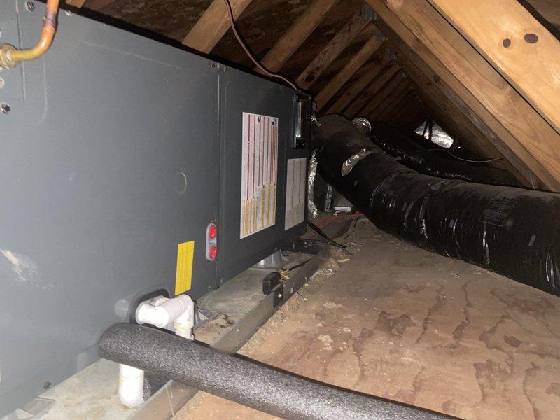 Conducted estimate consultation for boiler replacement system. Reviewed existing HVAC infrastructure including attic-mounted air handler unit with associated ductwork and electrical connections. Discussed alternative equipment options and configurations different from previous proposal to meet heating requirements. Documented current system installation including air handler positioning, black insulated ductwork routing, and confined attic space constraints. Provided technical recommendations for replacement unit specifications based on existing infrastructure and available installation space within sloped ceiling structure.