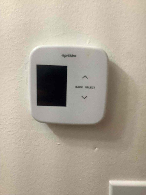 Responded to no-cooling call following power outage at residence with Rheem HVAC system and AprilAire thermostat. Upon arrival, found thermostat display completely blank with no power indication. Diagnosed loss of power to thermostat control circuit, traced issue to tripped breaker at main electrical panel caused by power surge during outage. Reset breaker and restored 24V control voltage to thermostat and system. Verified thermostat display powered on successfully, tested system operation through full cooling cycle, confirmed proper communication between thermostat and air handler, and verified normal compressor engagement. System restored to full operational status with all components functioning as designed.
