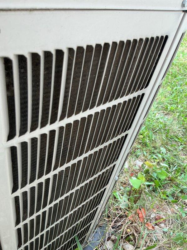 Performed comprehensive AC tune-up on aging outdoor condensing unit during morning service window. Completed full system inspection including electrical components, capacitor, contactor assembly, and all wire connections. Unit showed significant weathering and rust staining on housing consistent with extended outdoor exposure, but all components were functioning within normal parameters at time of service. Documented system condition with photos showing interior electrical components and exterior cabinet. System operating properly with no immediate repairs required.