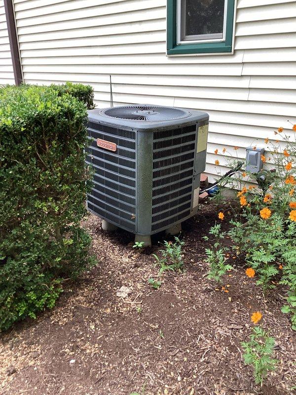 Performed diagnostic evaluation on 18-year-old Goodman split system air conditioning unit with outdoor condenser and high-ceiling garage air handler installation. System exhibited symptoms consistent with low refrigerant charge, requiring assessment of cooling performance and potential leak detection for the elevated air handler unit mounted at approximately 14 feet.