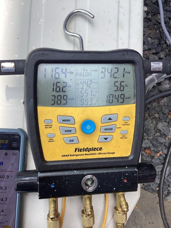 Responded to cooling inadequacy complaint where system only achieved 3-degree temperature drop after several hours of operation. Upon arrival, connected manifold gauges and performed complete system diagnostics on R410A unit. System pressures and temperatures indicated low refrigerant charge. Added refrigerant to manufacturer specifications under warranty coverage and injected leak sealant into system to address potential minor refrigerant loss. Monitored system performance and verified proper subcooling and superheat readings post-service.