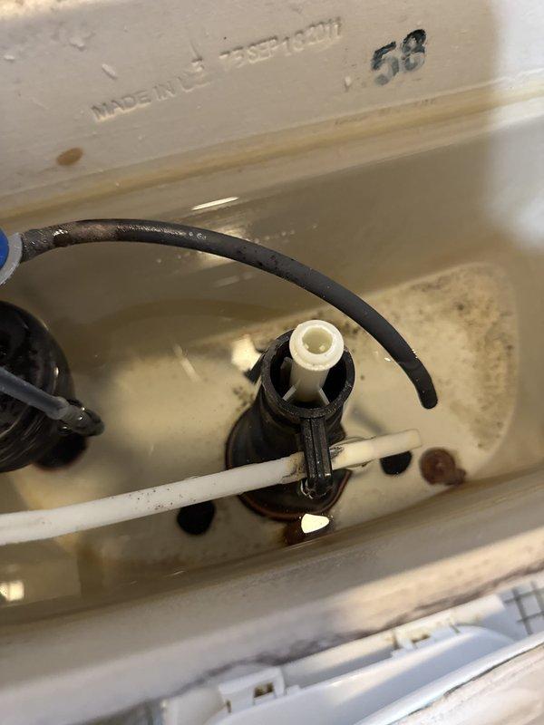 Responded to recurring leak from upstairs toilet causing water intrusion into basement area. Inspected toilet tank components and identified deteriorated fill valve assembly and compromised flapper valve as primary sources of leak. Tank interior showed significant mineral deposits and staining consistent with age and previous water quality issues. Fill valve exhibited worn seals and improper shutoff function, while flapper demonstrated loss of elasticity and incomplete sealing at flush valve seat. Documented existing conditions with photographs showing internal tank components, including corroded hardware and aged plumbing fixtures installed during 2016 renovation. Provided detailed estimate for replacement of fill valve assembly, flapper valve, and associated hardware to resolve leak and prevent further water damage to lower level. Recommended complete tank component replacement given age of existing parts and history of recurring issues in this 1938-era home.
