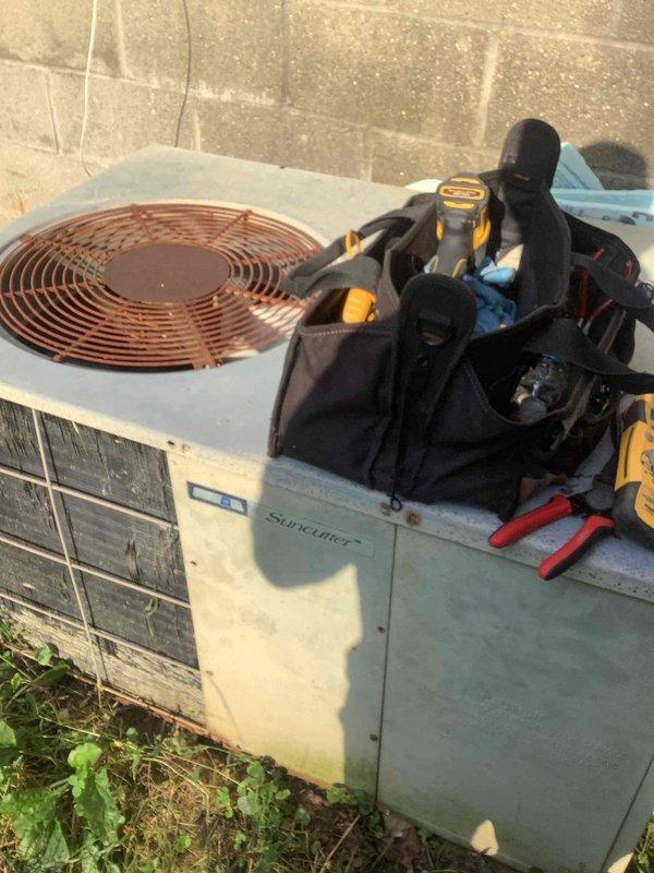 Responded to no-cooling complaint on residential split system air conditioning unit. Upon arrival, found outdoor condenser unit surrounded by overgrown vegetation and debris, restricting airflow to unit. Performed diagnostic testing of system components using digital multimeter and HVAC testing equipment. Cleared excessive weeds and plant growth from around condenser base and sides to restore proper airflow clearance. Inspected condenser coil, fan operation, and electrical connections. System restored to proper cooling operation after clearing obstructions and completing diagnostics.