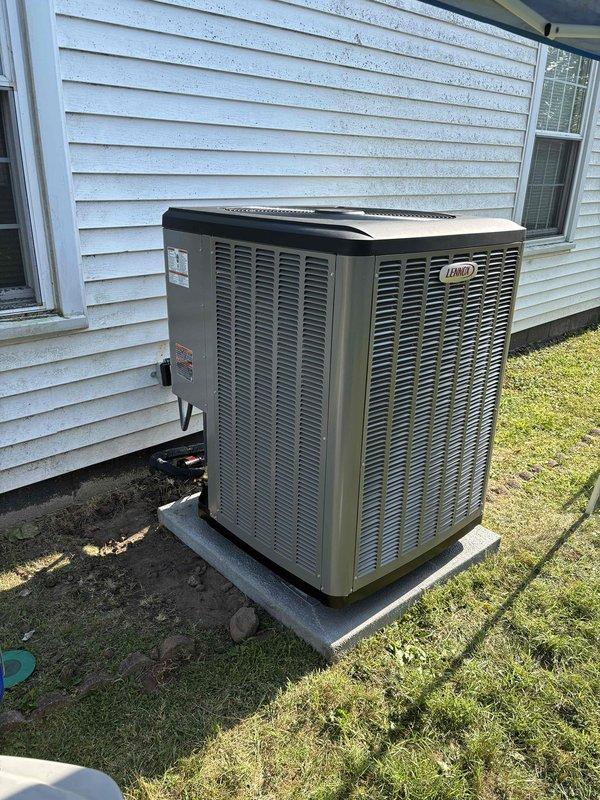 Completed full installation of Lennox heat pump and gas furnace system at residential property. Outdoor condenser unit properly positioned on concrete pad with adequate clearance for airflow and service access. Interior installation included low-level carbon monoxide detector with digital display, alarm functionality, and test/reset capabilities to ensure safe operation of gas-fired equipment.