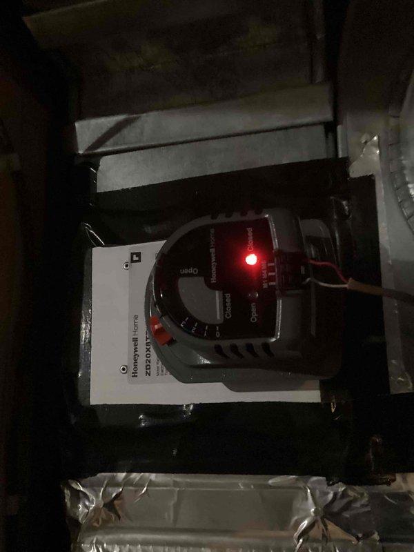 Returned to property to replace malfunctioning zone damper in HVAC system. Removed defective damper assembly and installed new Honeywell zone damper with motorized actuator. Verified proper operation of damper motor, confirmed red indicator light functioning correctly, and tested zone control response to thermostat signals.