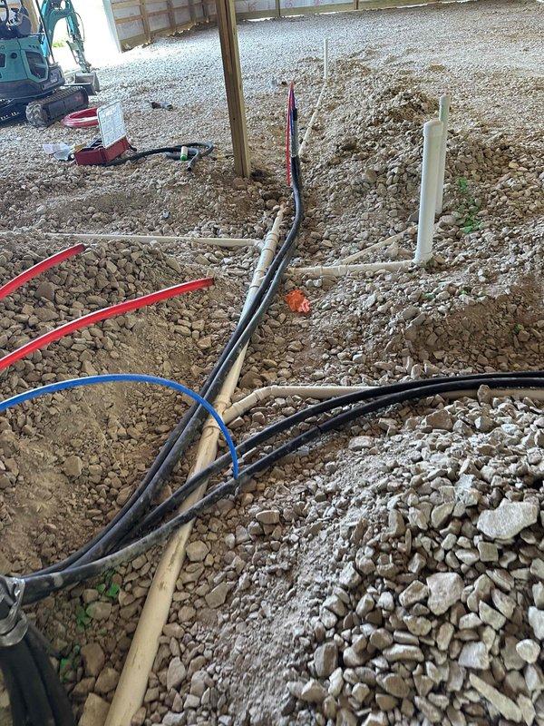 Completed plumbing rough-in for new construction slab application, installing water supply lines, drainage pipes, and electrical conduit runs through gravel base prior to concrete pour. All piping systems were positioned, secured, and verified for proper grade and placement in accordance with building plans, with insulation installed in wall cavities and site prepared for inspection.