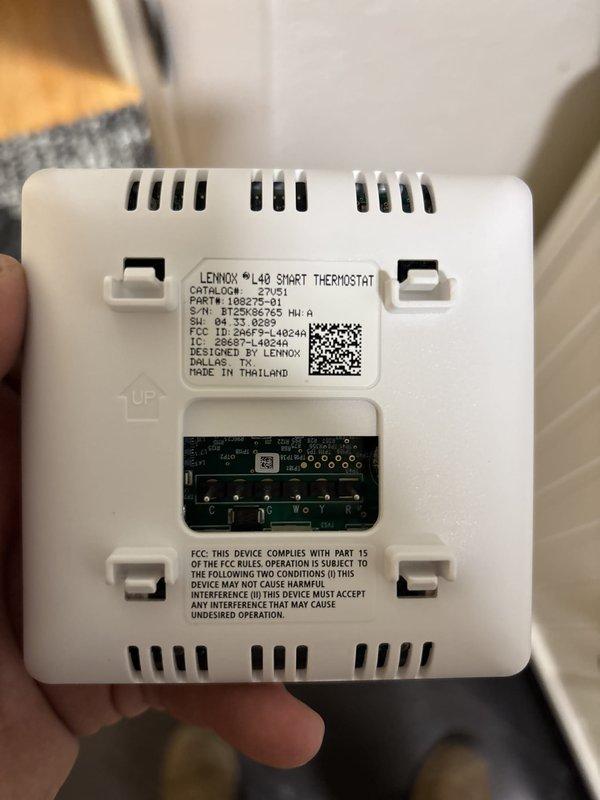 Completed installation of Lennox air conditioning system with matching evaporator coil. Installed and configured Lennox iLAQ smart thermostat (Model 32V51) with proper wiring and wall mounting. Verified system operation and confirmed temperature readings at 57.2°F, indicating proper cooling performance and successful startup of the new equipment.