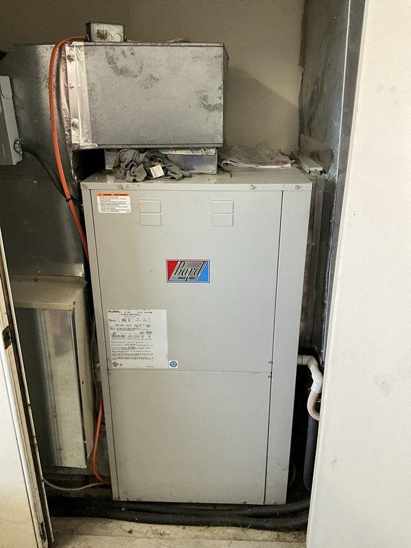 Conducted on-site assessment of aging geothermal HVAC system following recent capacitor replacement due to no cooling condition. Evaluated existing Nagel brand vertical ground-source heat pump unit installed in basement utility area, including associated air handler, ductwork distribution system, and ground loop plumbing connections. Documented current system configuration showing signs of age and wear, including corroded copper piping, oxidized metal components, and deteriorated plumbing connections throughout the geothermal loop system. Provided comprehensive replacement estimate for complete geothermal system upgrade to address customer's request for pricing on new equipment installation.
