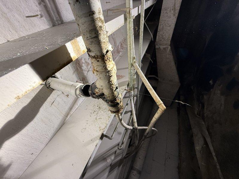 Responded to service call for low water pressure at kitchen faucet. Inspected crawlspace plumbing and identified severely corroded and deteriorated supply piping with significant rust buildup and mineral deposits affecting water flow. Documented existing conditions showing compromised pipe integrity at connection points and recommended replacement of affected sections to restore proper water pressure and prevent potential leaks.