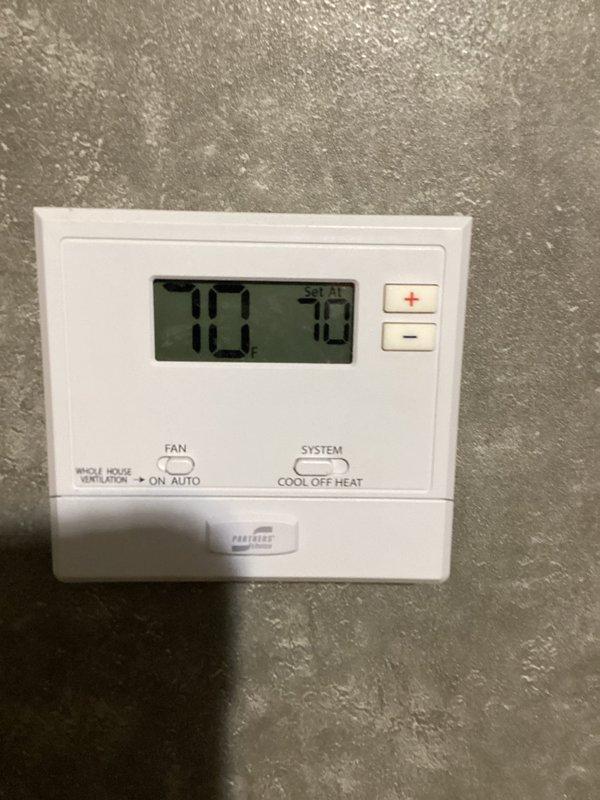Completed basic monthly cooling system maintenance visit. Inspected thermostat operation and verified temperature settings at 70 degrees with system controls functioning properly. Accessed indoor air handler unit, examined evaporator coil assembly and copper refrigerant lines, and cleaned washable filter as part of routine preventive maintenance to ensure optimal system performance.