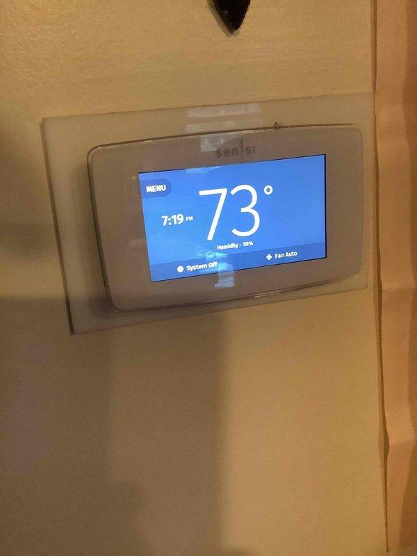 Completed basic monthly cooling maintenance visit on residential HVAC system. Inspected and verified thermostat operation showing system off with fan set to auto mode and indoor temperature at 73°F with 39% humidity. Documented existing air filter configuration with dual 16x25x4 MERV 11 filters in metal track system, noting filters were not included in this service agreement and require replacement based on installation dates observed.