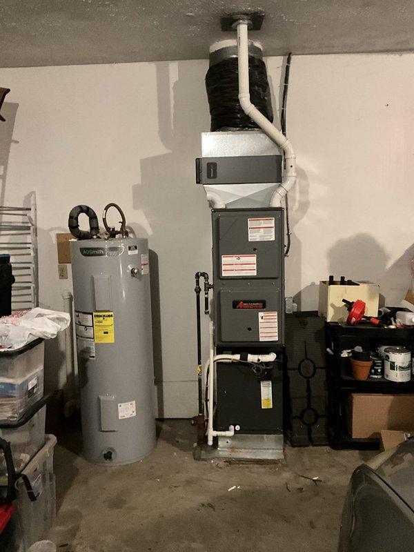 Conducted on-site evaluation for cooling system and dehumidifier installation in residential property. Assessed existing HVAC infrastructure including furnace unit and water heater configuration in basement utility area, documented electrical panel capacity and circuit availability, and captured detailed photographs of equipment layout to prepare comprehensive estimate for indoor air quality improvements.