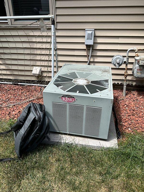 Completed HVAC system replacement estimate for residential property. Documented existing Weather King outdoor condensing unit and indoor furnace system currently installed in basement utility room. Photographed current equipment configuration including furnace with PVC venting, flexible ductwork connections, and outdoor condenser positioned on concrete pad with proper clearances. System assessment performed to provide replacement options for complete heating and cooling system upgrade.
