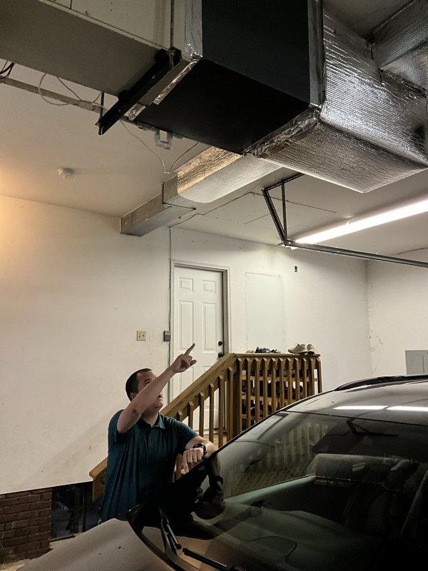 Responded to service call for 18-year-old ceiling-mounted HVAC unit in garage experiencing recurring refrigerant loss. Conducted assessment of system mounted at 14-foot ceiling height and documented existing equipment configuration including air handler, ductwork, and associated components. Provided replacement estimate for aging unit due to repeated refrigerant charging requirements indicating potential system failure.