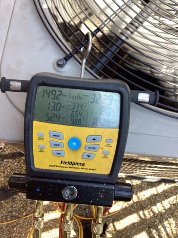 Responded to callback for no cooling complaint on 1-year-old air conditioning system with whole house temperature exceeding 80°F despite recent service. Upon arrival, performed comprehensive system diagnostics using manifold gauges and digital instrumentation to assess refrigerant pressures, temperatures, and overall system performance at the outdoor condensing unit. Supply air temperature measured at floor register showed inadequate cooling at 65.6°F, confirming insufficient system capacity. Diagnosed root cause of cooling deficiency through systematic evaluation of refrigerant charge, airflow, and component operation. Corrected identified issue and verified proper system operation with all parameters within manufacturer specifications. System restored to full cooling capacity with appropriate temperature differential achieved across evaporator coil.
