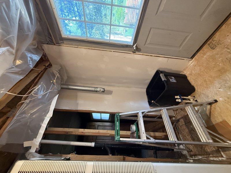 Conducted on-site assessment for comprehensive plumbing renovation project involving installation of gas water heater, two bathtubs, and master bathroom double-sink vanity requiring complete reconfiguration of existing supply and waste piping systems. Evaluated active construction area with exposed framing and structural elements to determine optimal routing for gas lines, hot and cold water supply lines, and drain-waste-vent systems to accommodate new fixtures and meet current plumbing code requirements.