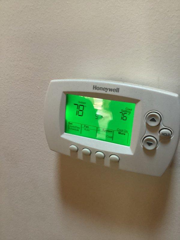 Responded to service call for geothermal system experiencing intermittent cooling issues and tripping breakers. Upon arrival, verified thermostat reading of 78 degrees and confirmed compressor operation. Performed electrical diagnostic testing using clamp meter, measuring 33.40 amps at compressor circuit. Identified intermittent electrical fault causing breaker trips despite compressor running. Noted condensation tray was dry, indicating potential airflow or refrigerant issue affecting cooling capacity. Documented system conditions with thermostat and electrical measurements for further diagnosis and repair recommendations.