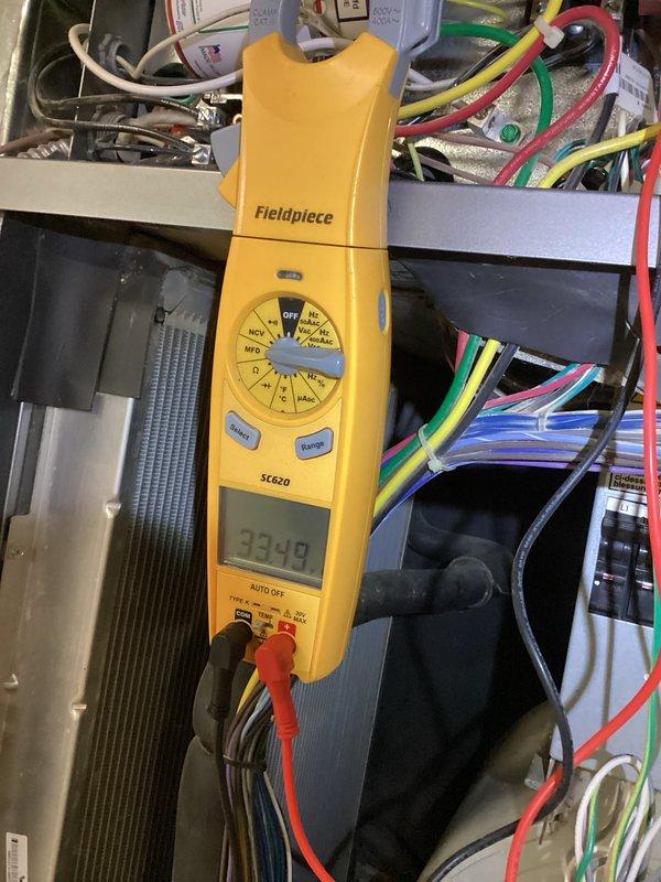 Responded to service call for geothermal system experiencing intermittent cooling issues and tripping breakers. Upon arrival, verified thermostat reading of 78 degrees and confirmed compressor operation. Performed electrical diagnostic testing using clamp meter, measuring 33.40 amps at compressor circuit. Identified intermittent electrical fault causing breaker trips despite compressor running. Noted condensation tray was dry, indicating potential airflow or refrigerant issue affecting cooling capacity. Documented system conditions with thermostat and electrical measurements for further diagnosis and repair recommendations.
