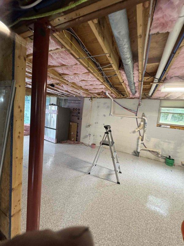 Relocated existing refrigerant line set, main electrical supply, and thermostat wiring to accommodate new HVAC air handler positioning in basement mechanical room. Successfully reused all existing materials including copper refrigerant lines, electrical conductors, and low-voltage control wiring, rerouting through exposed joist space to new equipment location. Unit installed on concrete pad with proper clearances, all connections secured and tested for proper operation.