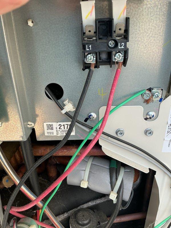 Completed routine maintenance on 4-year-old heating and cooling system per customer request. Performed comprehensive AC tune-up including inspection of electrical connections at L1 and L2 terminals, verified proper wire terminations and grounding connections, and examined control panel wiring and components. Inspected capacitor, refrigerant lines, and internal components for proper operation. Cleaned accumulated dust and debris from electrical compartment and verified all safety labels and warnings were intact and legible. Confirmed all electrical connections were secure with no signs of overheating or corrosion. System tested and operating within normal parameters with no issues identified.