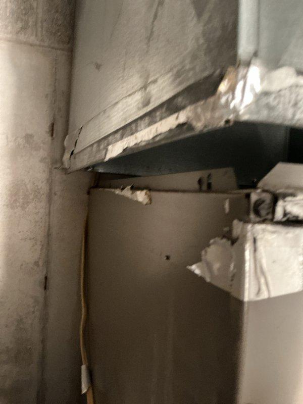 Responded to warranty callback for disconnected supply trunk line at indoor air handler unit. Upon inspection, confirmed supply ductwork had separated from evaporator coil connection point. Properly reconnected and secured supply trunk line to evaporator coil housing, ensuring proper seal and airflow path. System tested and verified operational with restored air distribution.
